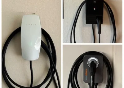 A collage of three electric vehicle chargers mounted on a wall: a white Tesla charger on the left, a black charger at the top right, and a gray Wallbox charger with orange text at the bottom right. All have coiled charging cables.